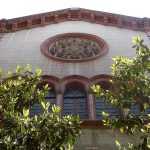 Parte superior de la iglesia, con ventanas, rosetón y alero